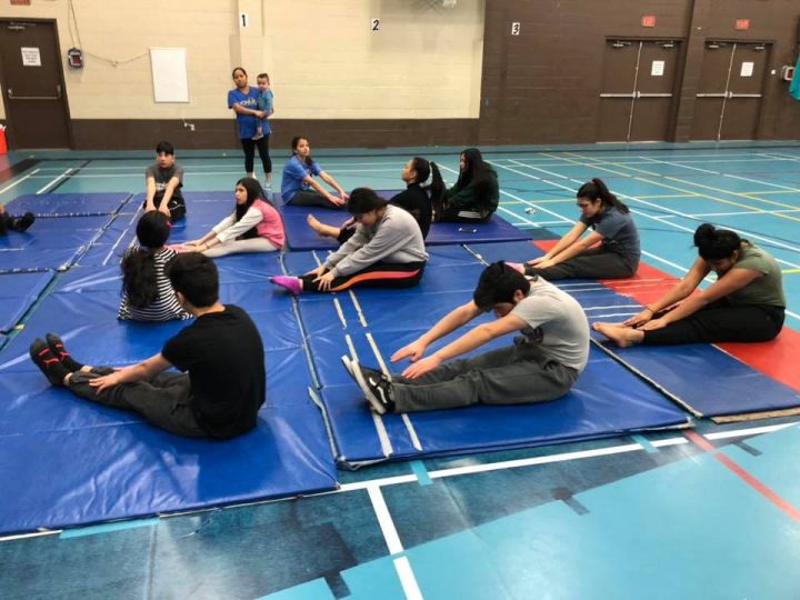 Pathfinders doing stretching exercises in preparation for gymnastics
